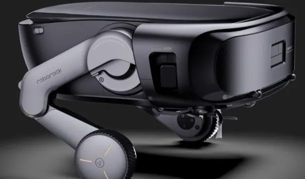 A futuristic robotic fourwheeled device with an arm labeled Roborock Saros Rover