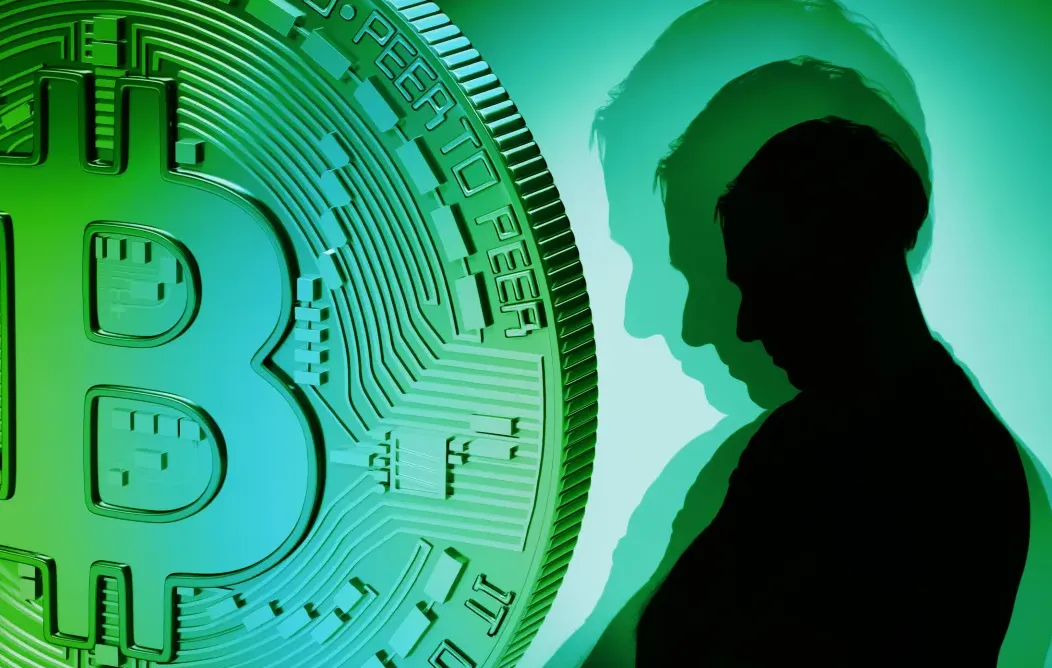 Simbol Bitcoin besar berwarna hijau dan biru di sebelah kiri, dengan siluet seseorang di sebelah kanan yang memiliki beberapa bayangan di atas latar belakang hijau, menggambarkan tema digital atau cryptocurrency.