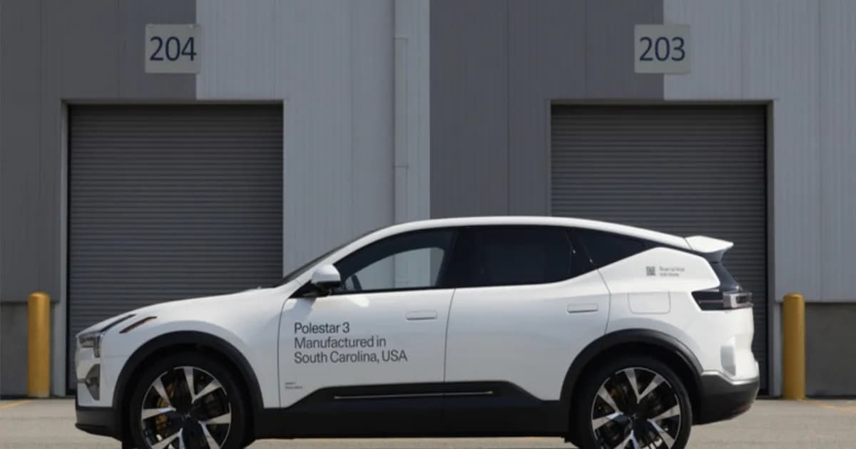 Polestar 3 SUV listrik putih di depan garasi gudang abu-abu