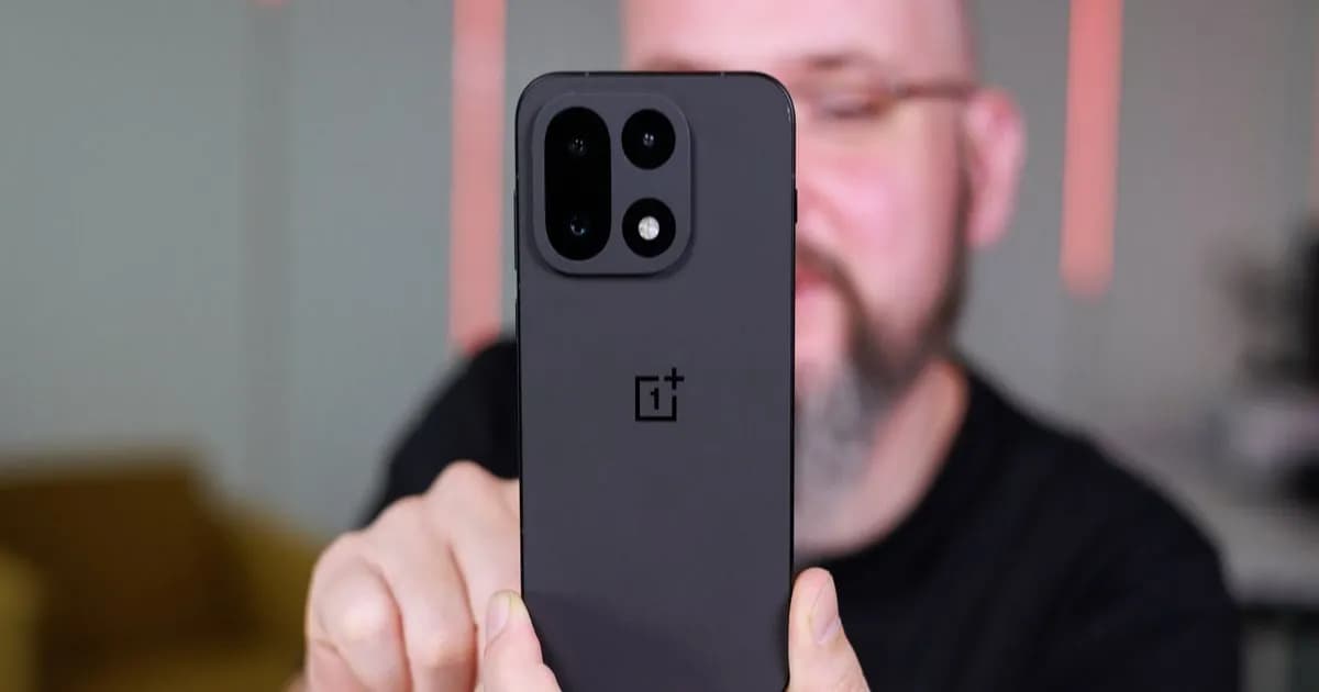 Hand holding a OnePlus 15, rear camera module visible