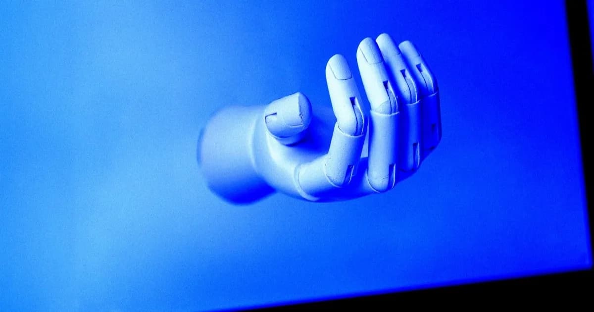 Ilustrasi tangan robot di atas layar laptop yang merepresentasikan agen AI iLands mengirim surel mengemis kerja.