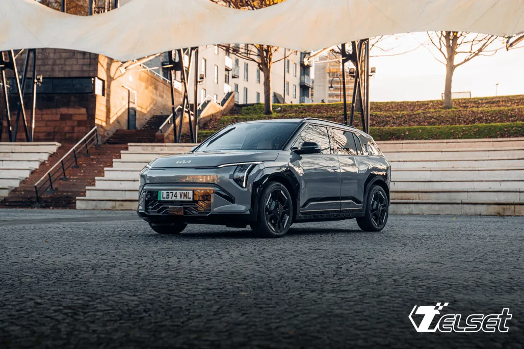 Kia EV3, pemenang World Car of the Year 2025, diparkir di jalan perkotaan dengan latar gedung modern