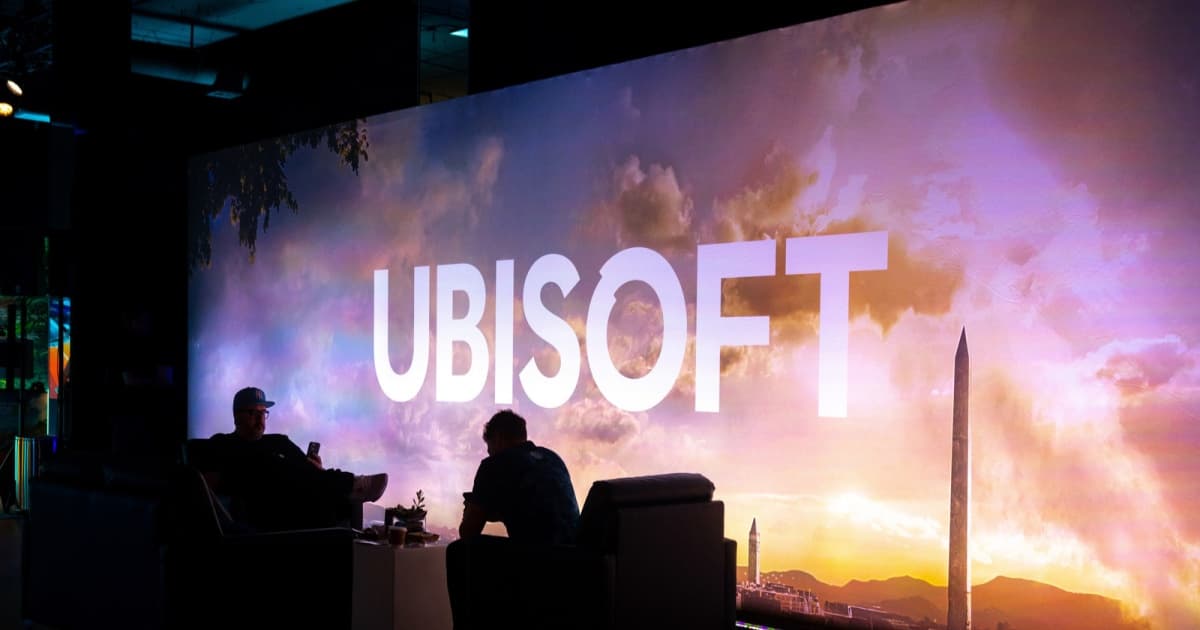 Logo Ubisoft dengan bayangan dua orang duduk di depannya