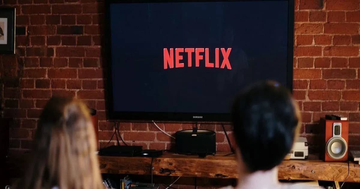 Netflix logo on phone screen and desktop app