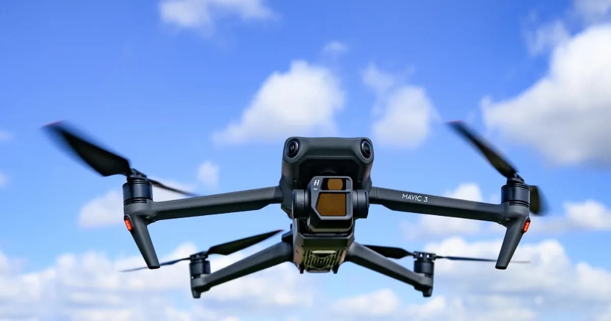 Drone DJI terbang di langit biru dengan awan