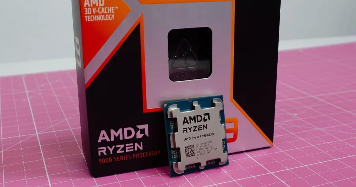 AMD Ryzen 9 9950X3D chip dengan kemasannya di atas meja pink