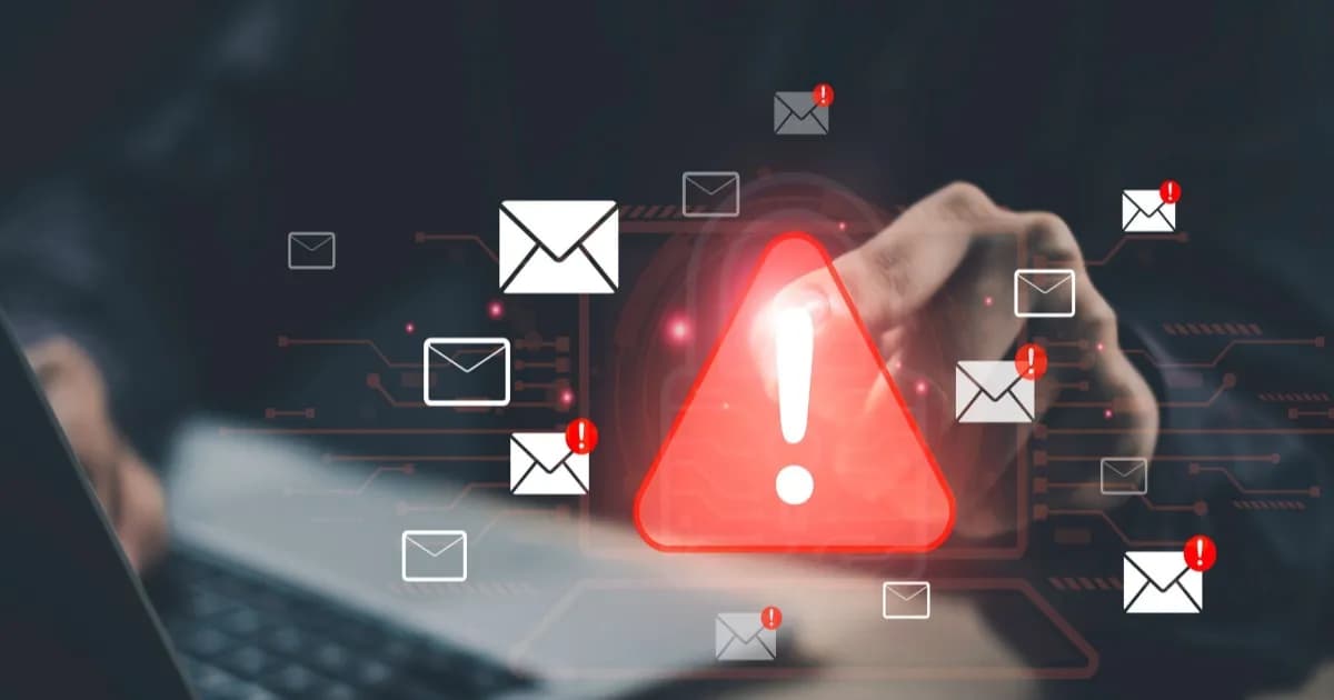 Ilustrasi peringatan keamanan siber dengan segitiga merah dan simbol email di atas laptop