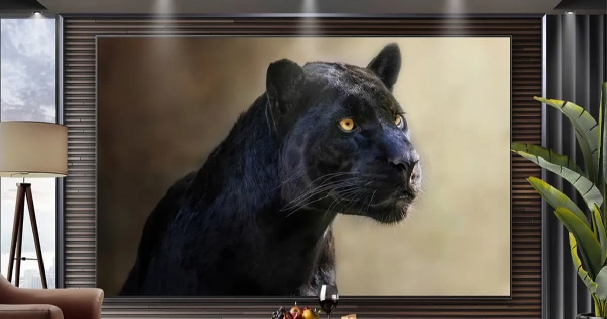 Promotional image of the LG 97 inch OLED showing a panther against a light brown background, wall mounted in a room with contemporary decor and wood panelling