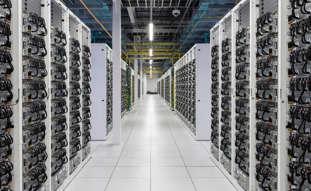 Modern data center with rows of servers in a spacious, well-lit room.