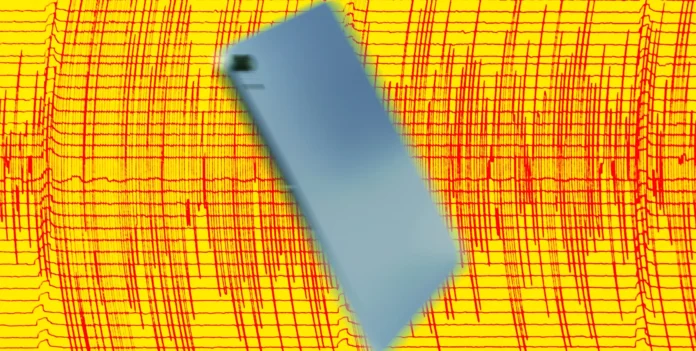 Ilustrasi ponsel Android menampilkan peringatan gempa dengan latar belakang getaran seismik