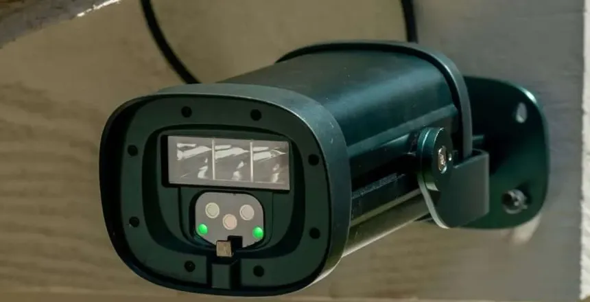 A surveillance camera mounted on a wall.