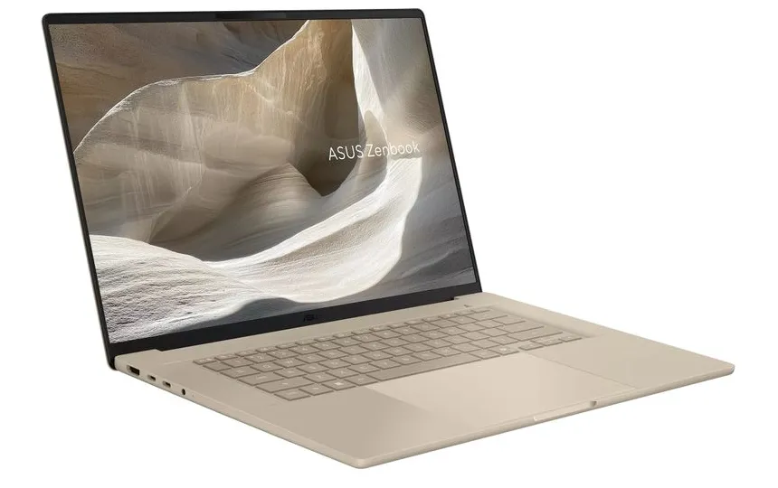 A laptop with a large display showcasing a canyon wallpaper ASUS Zenbook branding visible on the screen