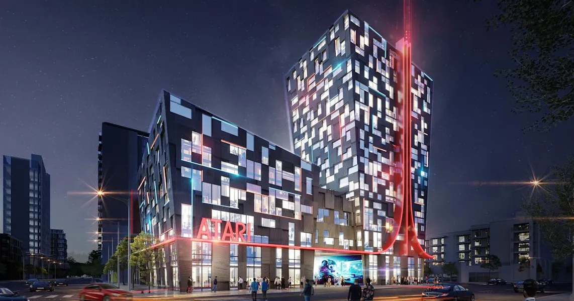 Ilustrasi konsep desain eksterior Atari Hotels dengan logo ikonik berwarna merah menyala di malam hari.